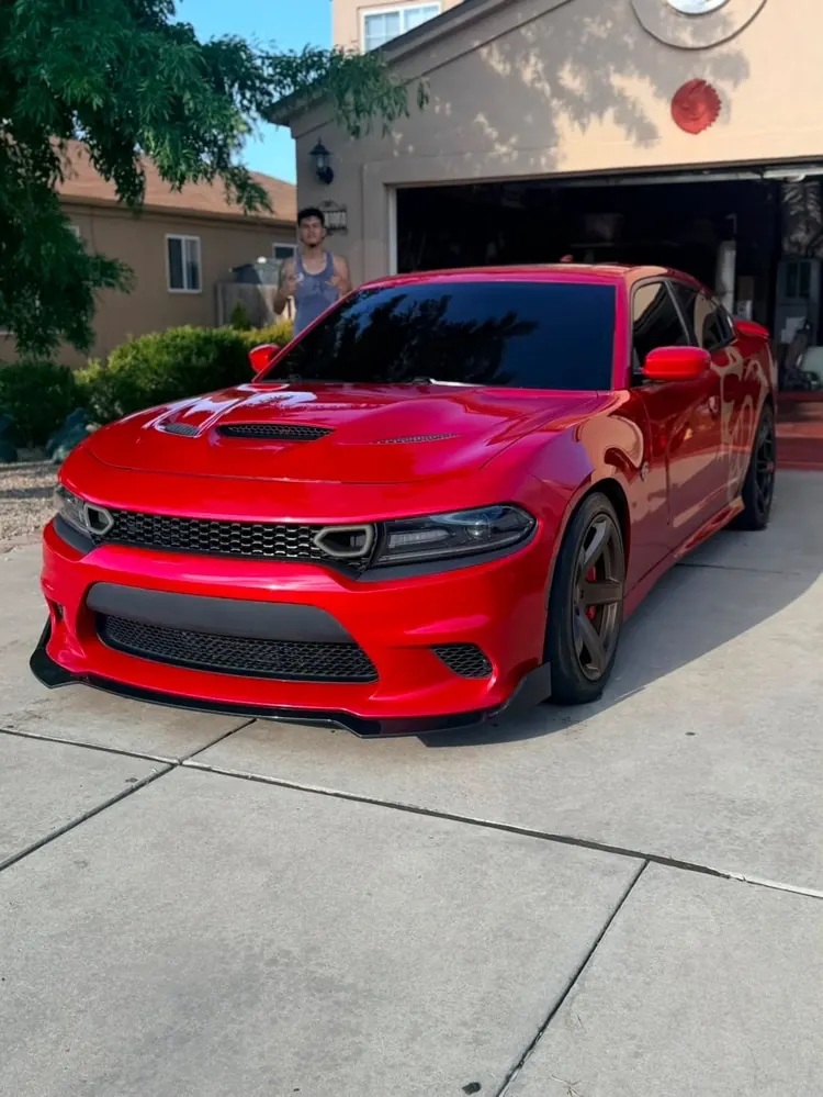 Freshly detailed red Dodge Charger in the driveway